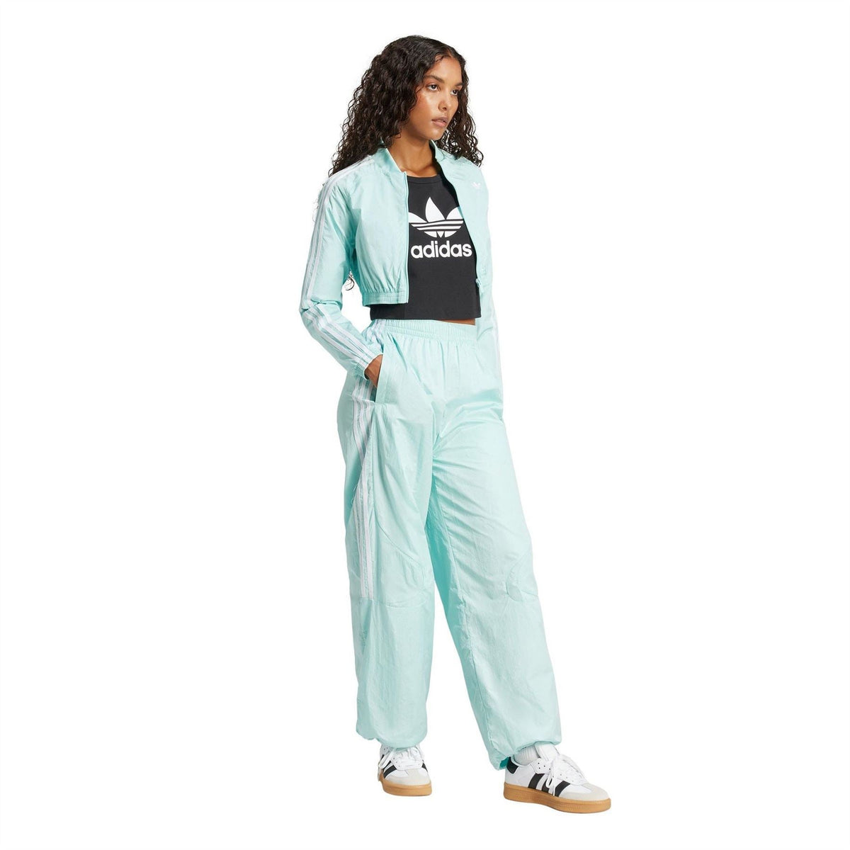Light aqua adidas Originals track pants with elastic waist and side stripe accents