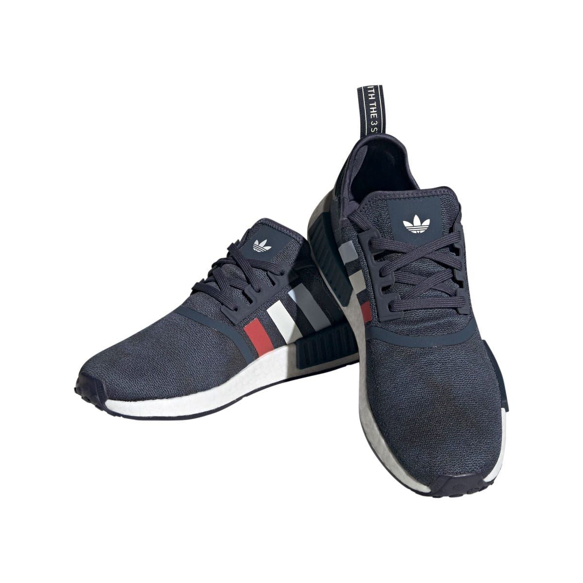 Navy adidas NMD R1 trainers, angled front and side view, white cushioned midsole
