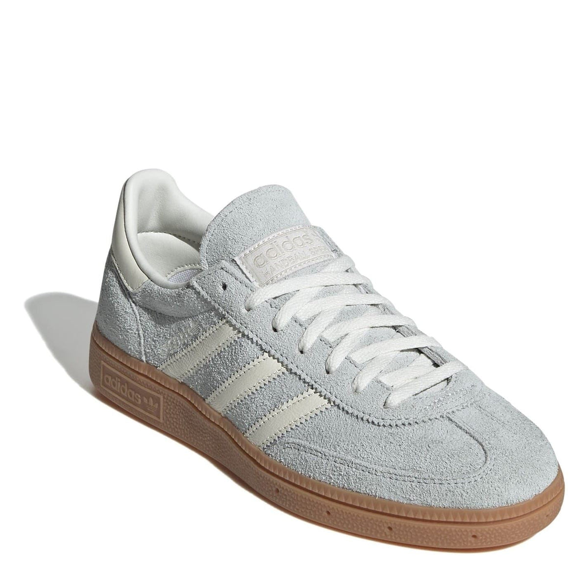 Light gray suede low-top sneakers with lace-up front and brown gum sole