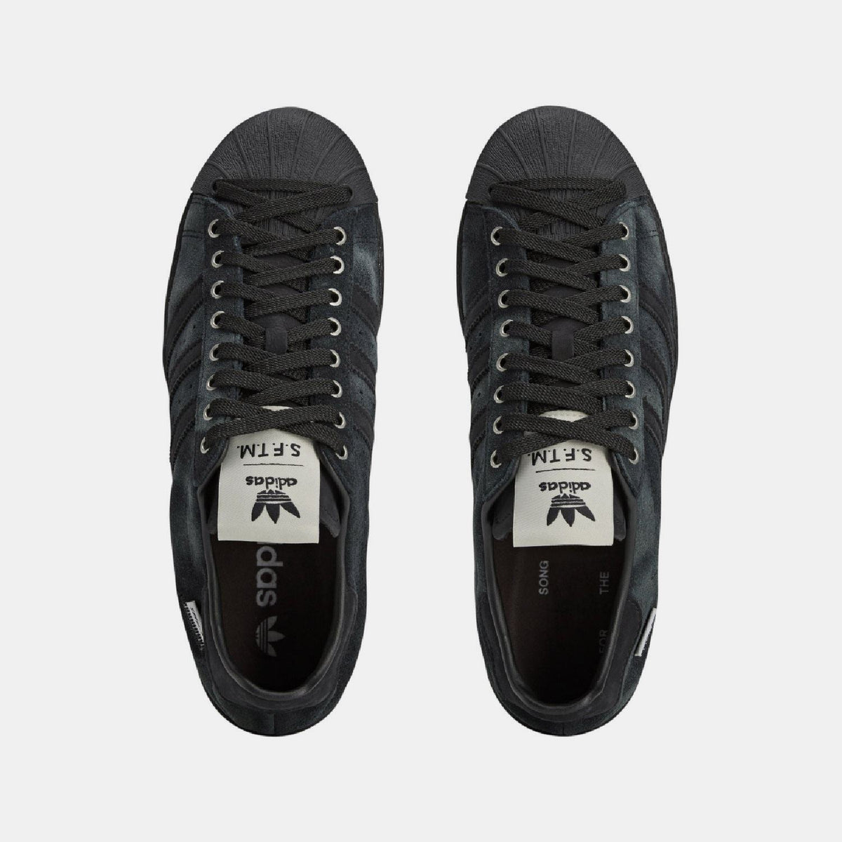 adidas Originals SFTM Superstar 82 trainers featuring classic design, white leather upper, and rubber sole for stylish comfort