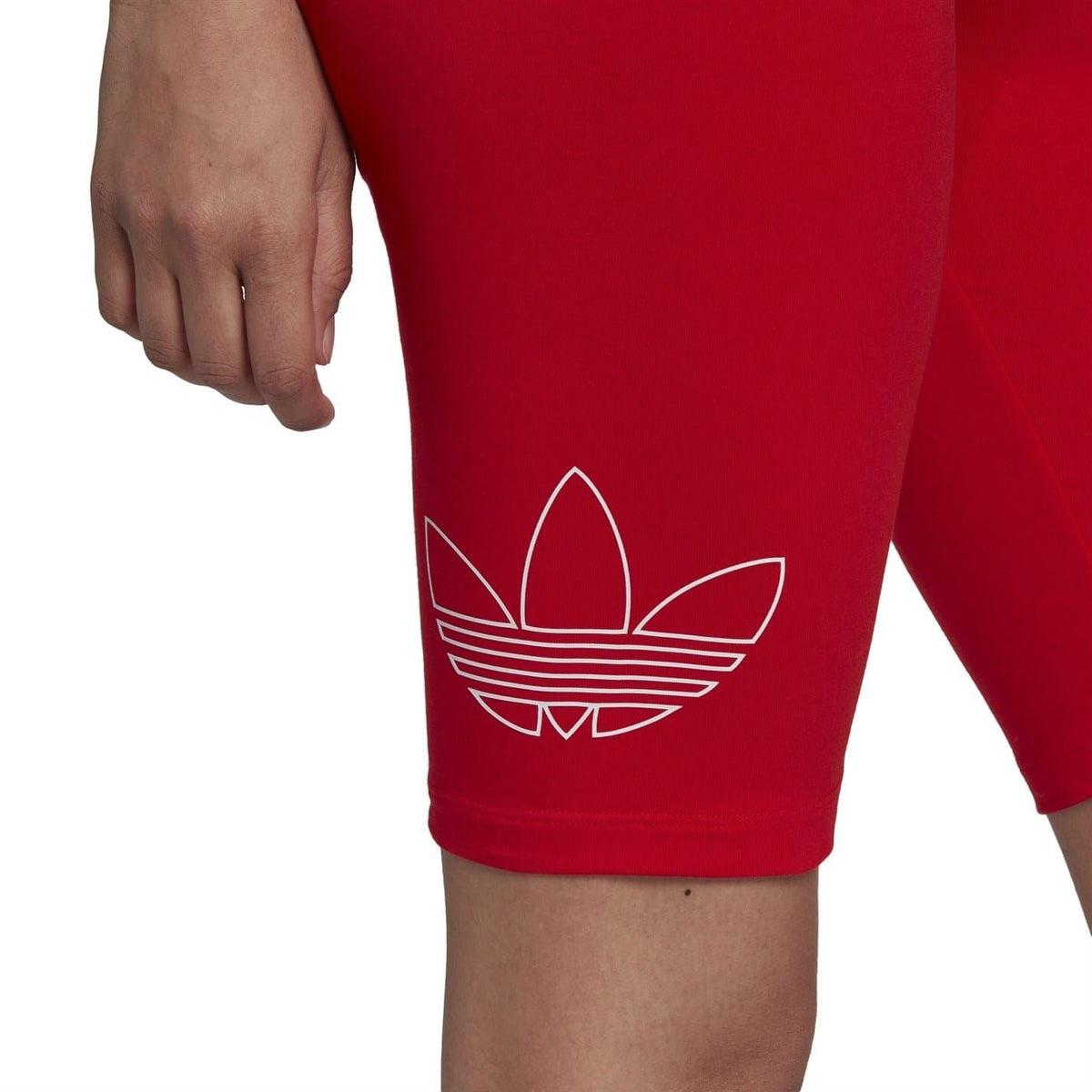 Red athletic bike shorts with large adidas trefoil logo on lower leg