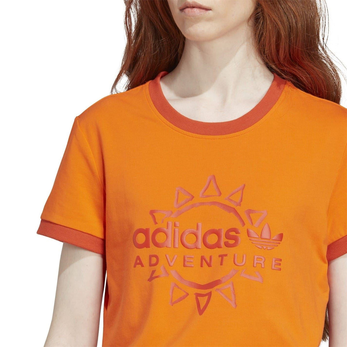 Orange crewneck T-shirt with large adidas Adventure logo on the chest
