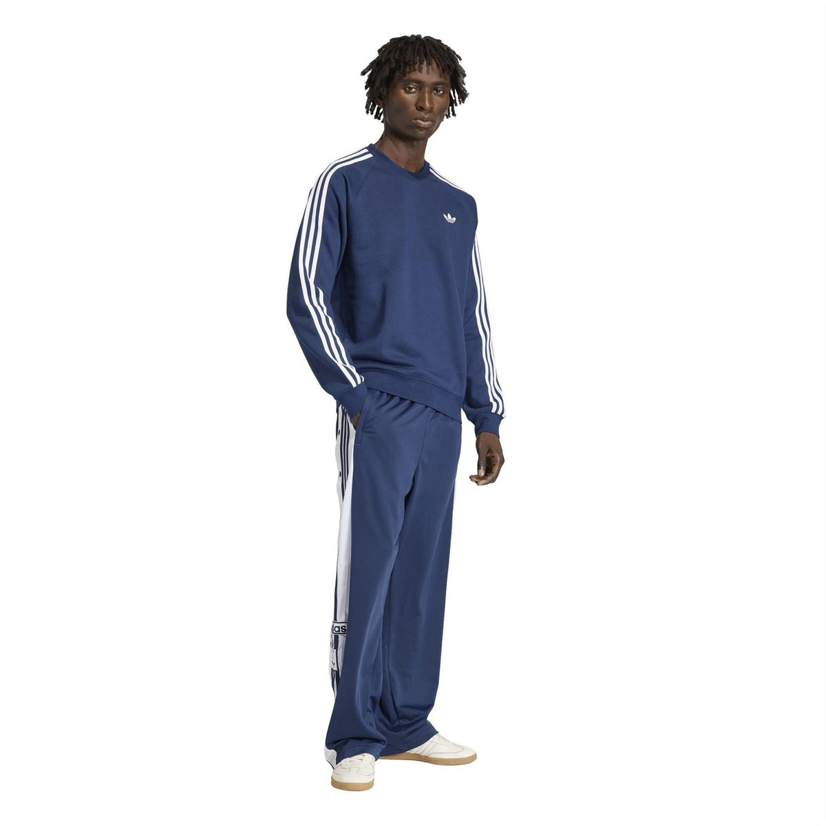 Men's indigo track joggers with adidas side stripes and elastic waist, full length