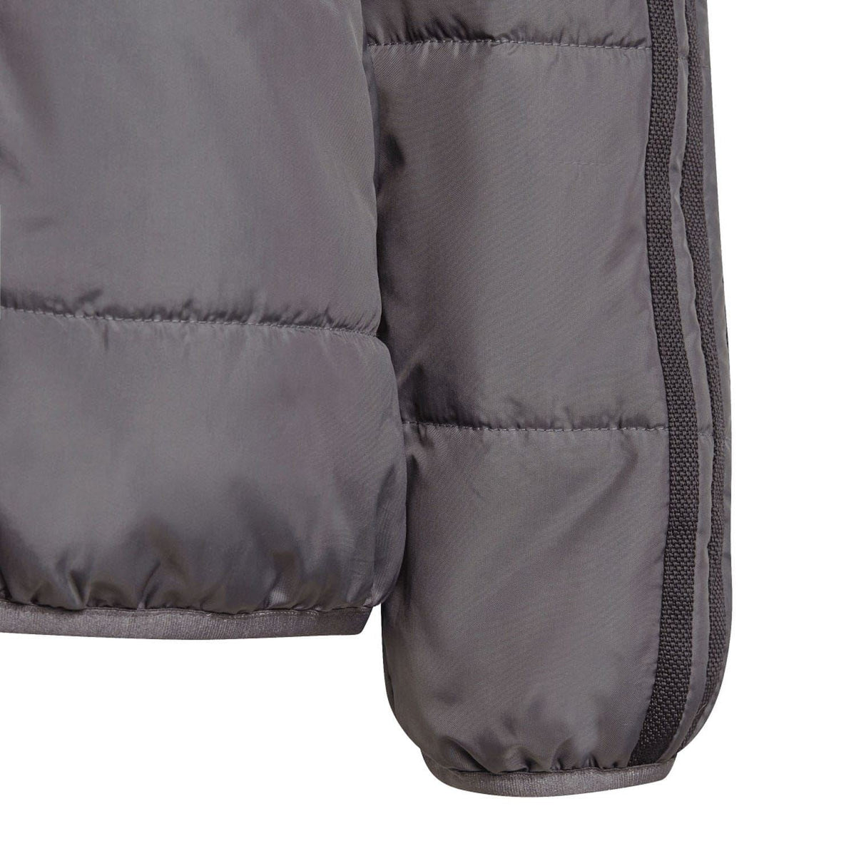 Grey padded kids jacket sleeve cuff with elastic trim and side seam panel