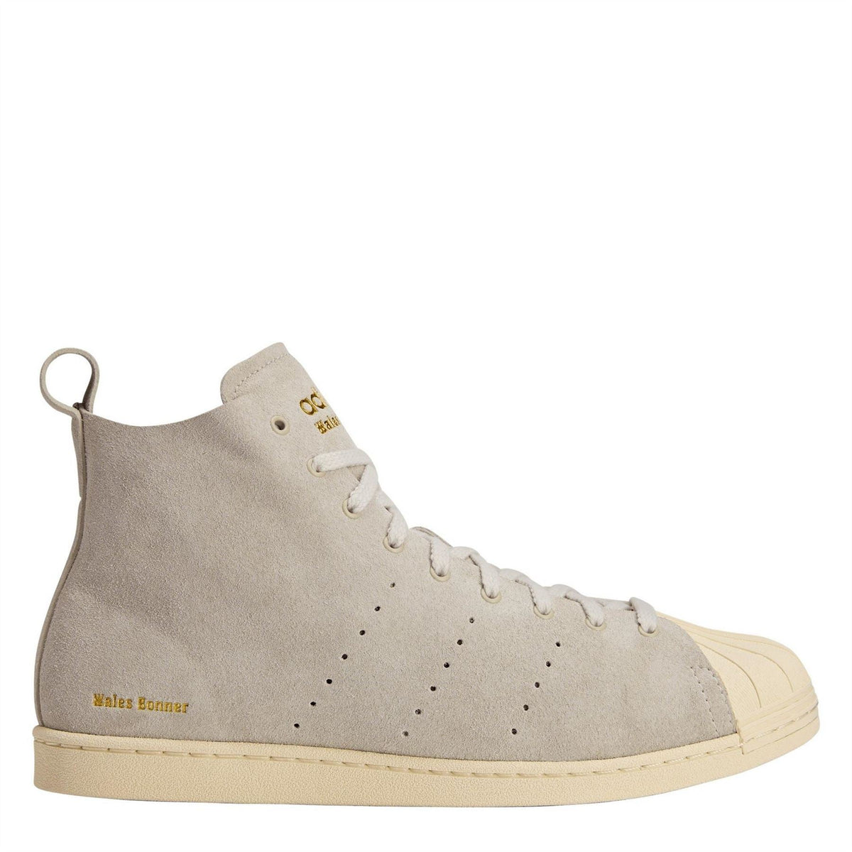 Cream suede high-top sneakers with perforated toe, lace-up front, cream rubber sole.
