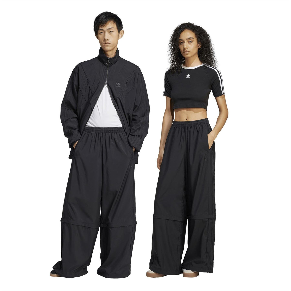 Black wide-leg track pants with elastic waist, patch pockets, and relaxed straight fit.
