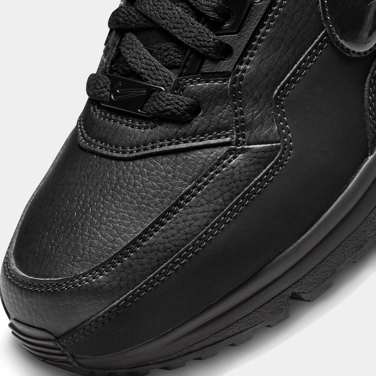 Nike Air Max LTD 3 black leather upper close-up with stitched seams and laces