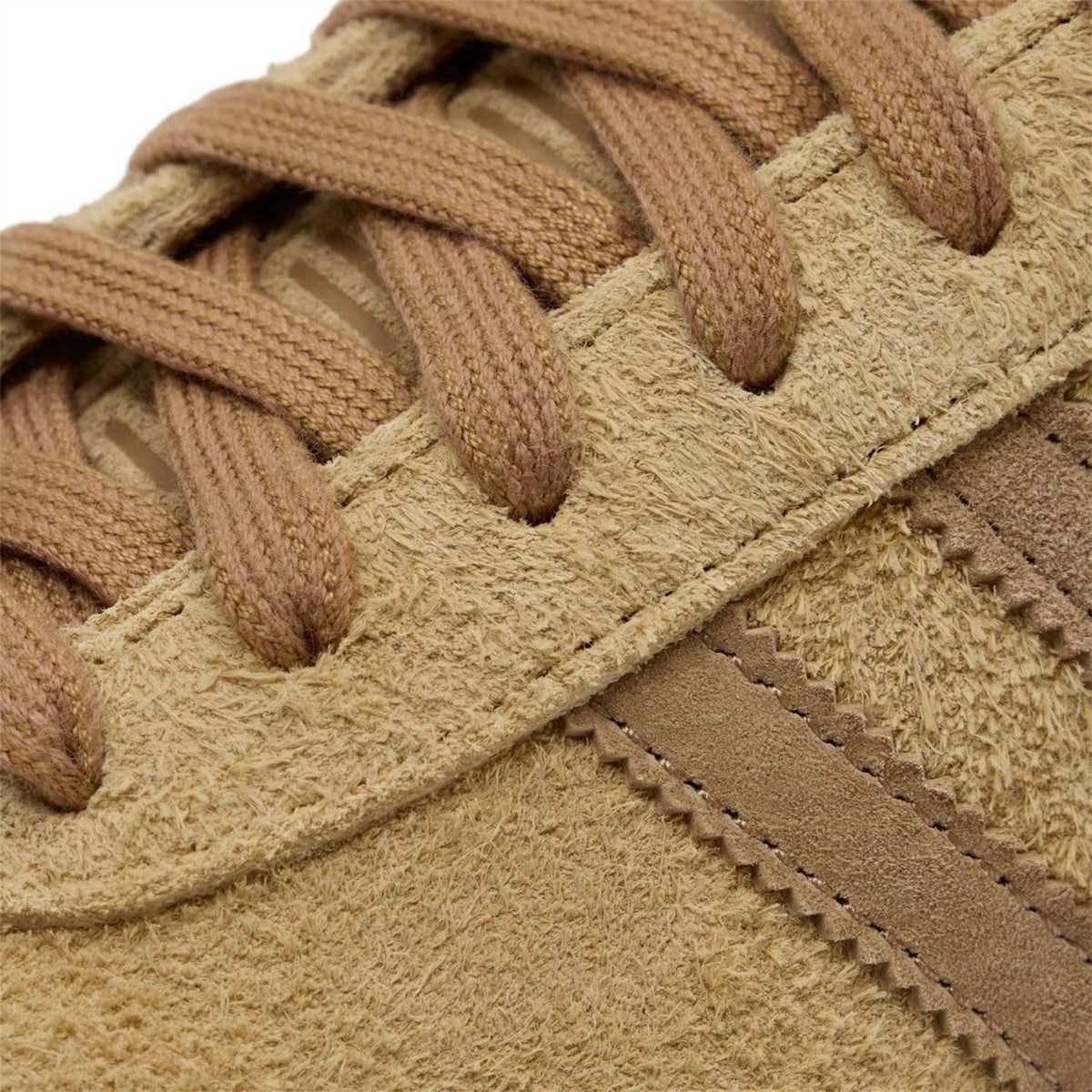 Close-up of tan suede adidas Samba trainers, braided laces and stitched panel details
