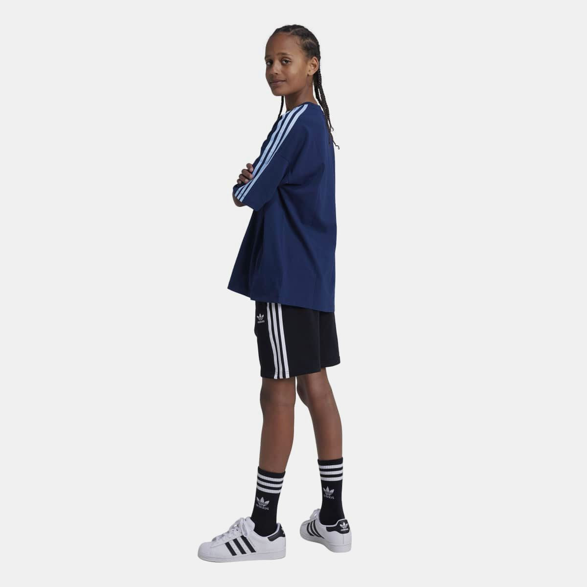 Adidas Originals Juniors Adicolor shorts in vibrant pink and blue, featuring elastic waistband and sporty design for kids aged 8-16.