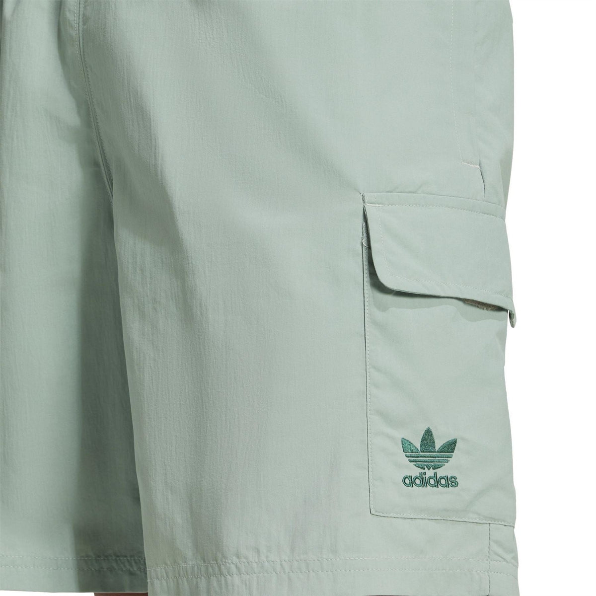 Mint green shorts with cargo pocket flap and adidas logo patch