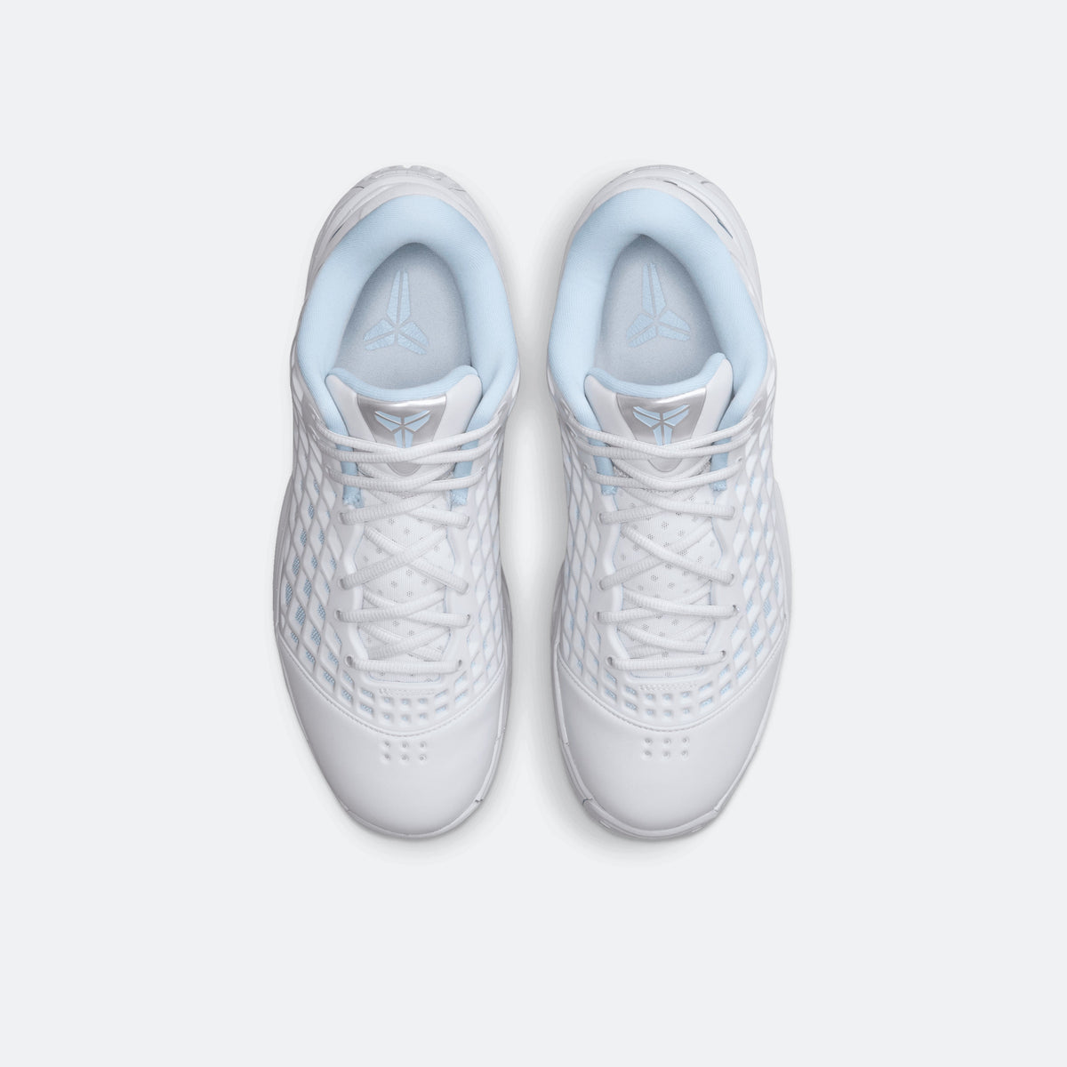 White and light blue basketball shoes viewed from the top with lace-up eyelets