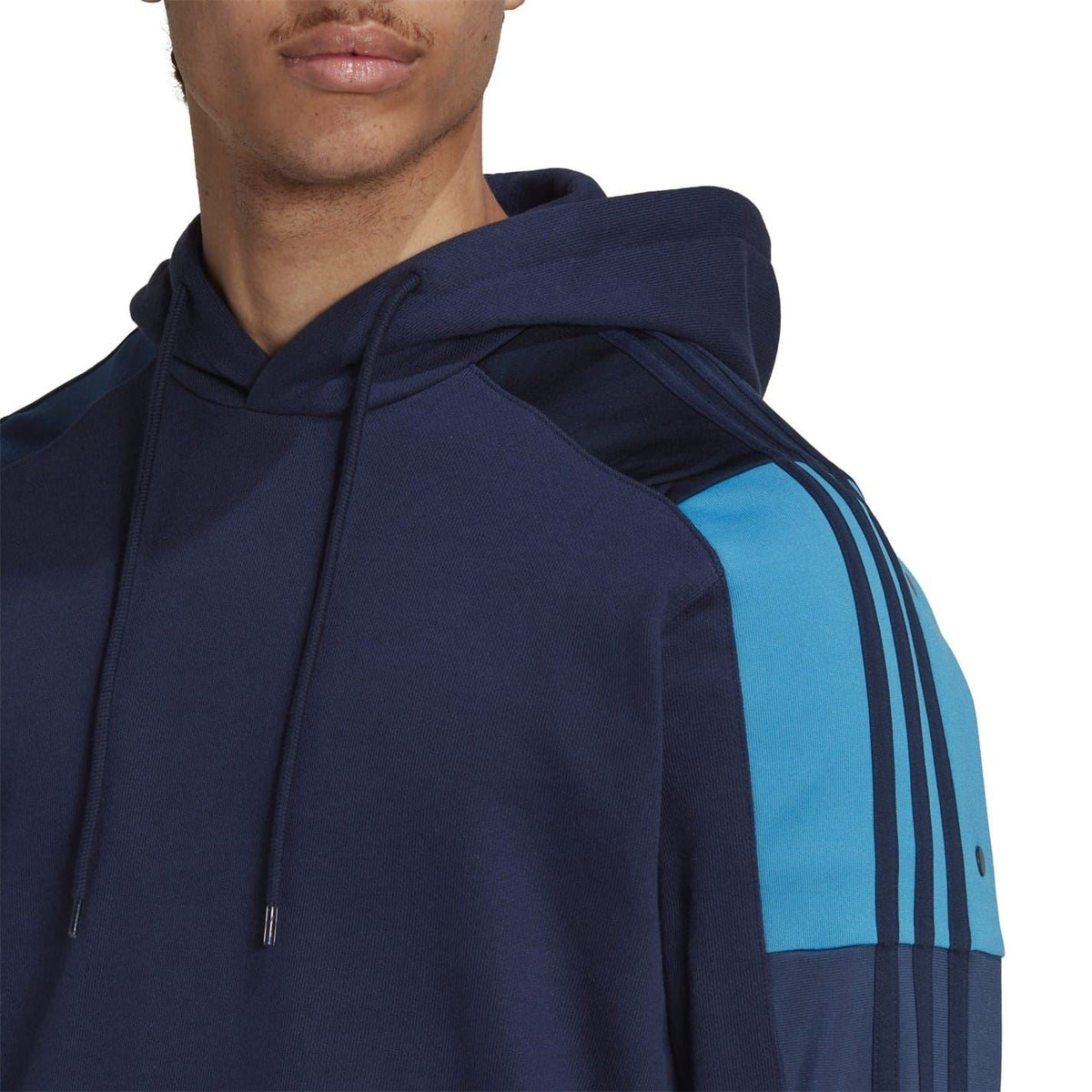 Navy hooded sweatshirt close-up with light-blue shoulder panel and drawstring hood.
