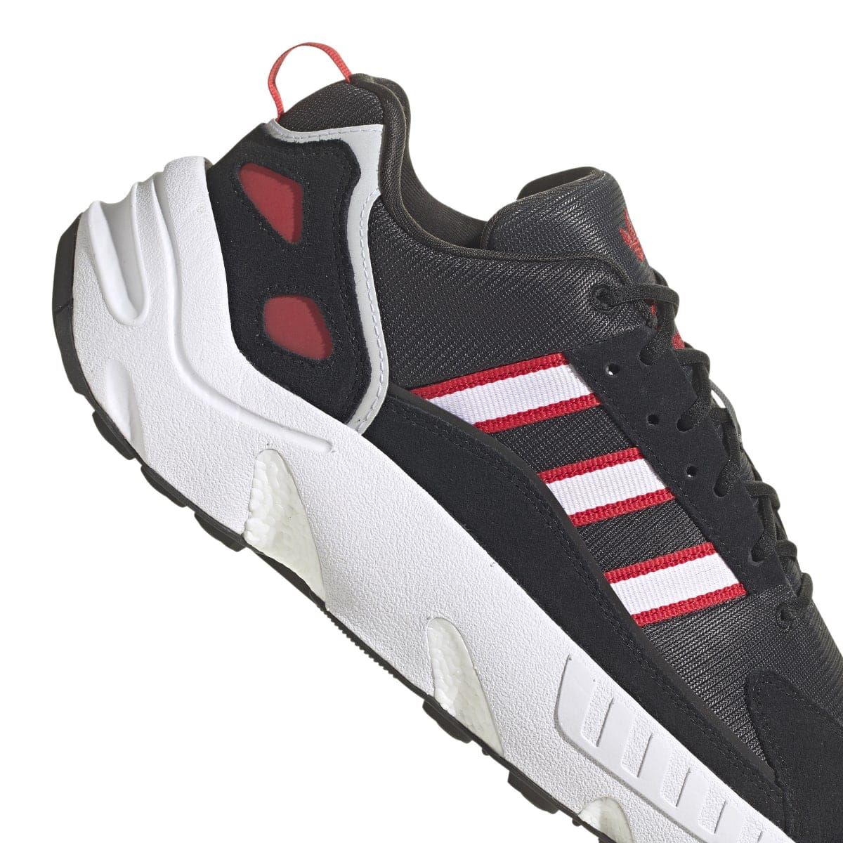 Black ZX 22 Boost trainers with red accents, white side stripes, and thick white sole