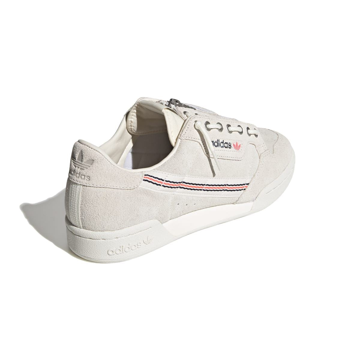 Light beige suede trainers from heel view with adidas logo on back tab