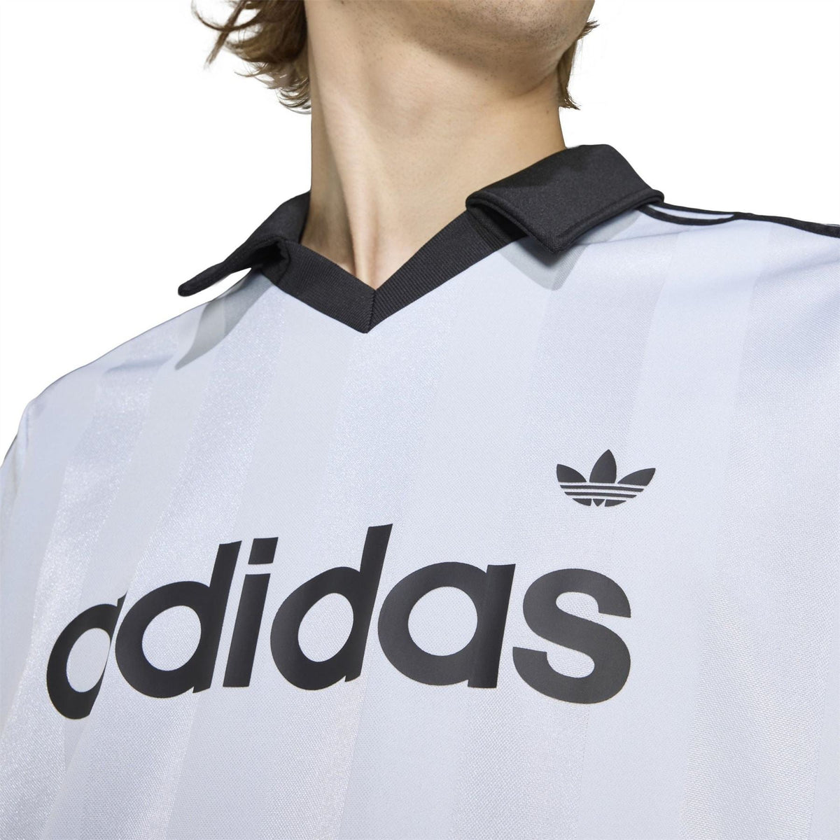 Light blue adidas polo shirt neckline detail with black collar and trefoil logo