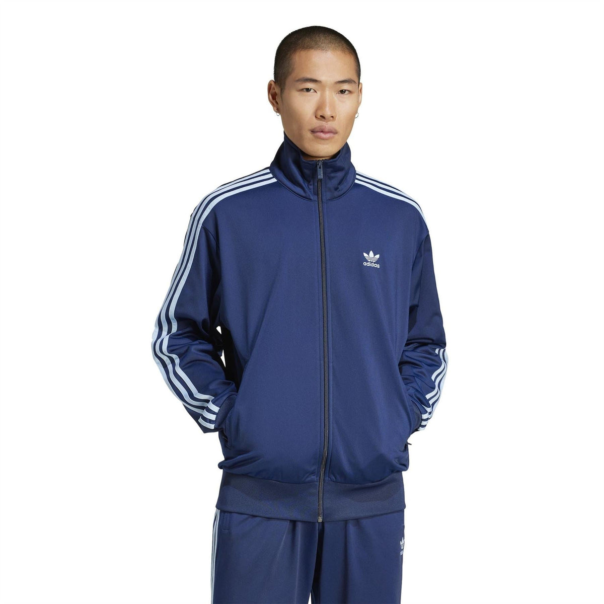 adidas Originals Firebird TT night indigo track jacket on model, full-zip and stripe sleeves