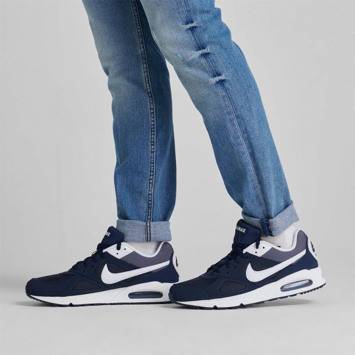 Navy and white Nike Air Max trainers with swoosh and air-cushion sole