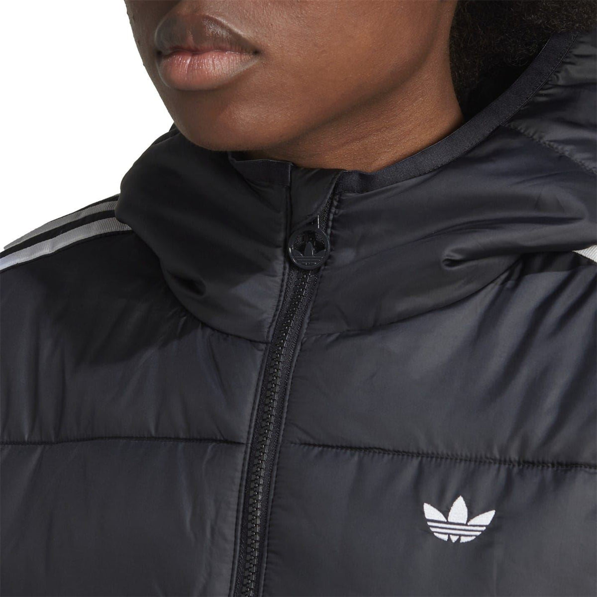 Black hooded puffer jacket close-up with front full-zip and adidas Originals trefoil logo.