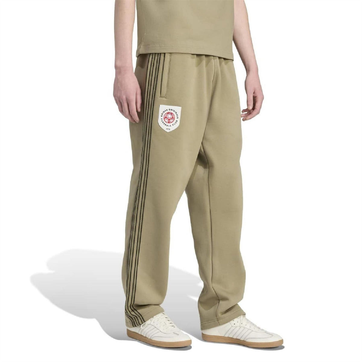 Olive-green joggers with side crest patch and three dark stripe seams