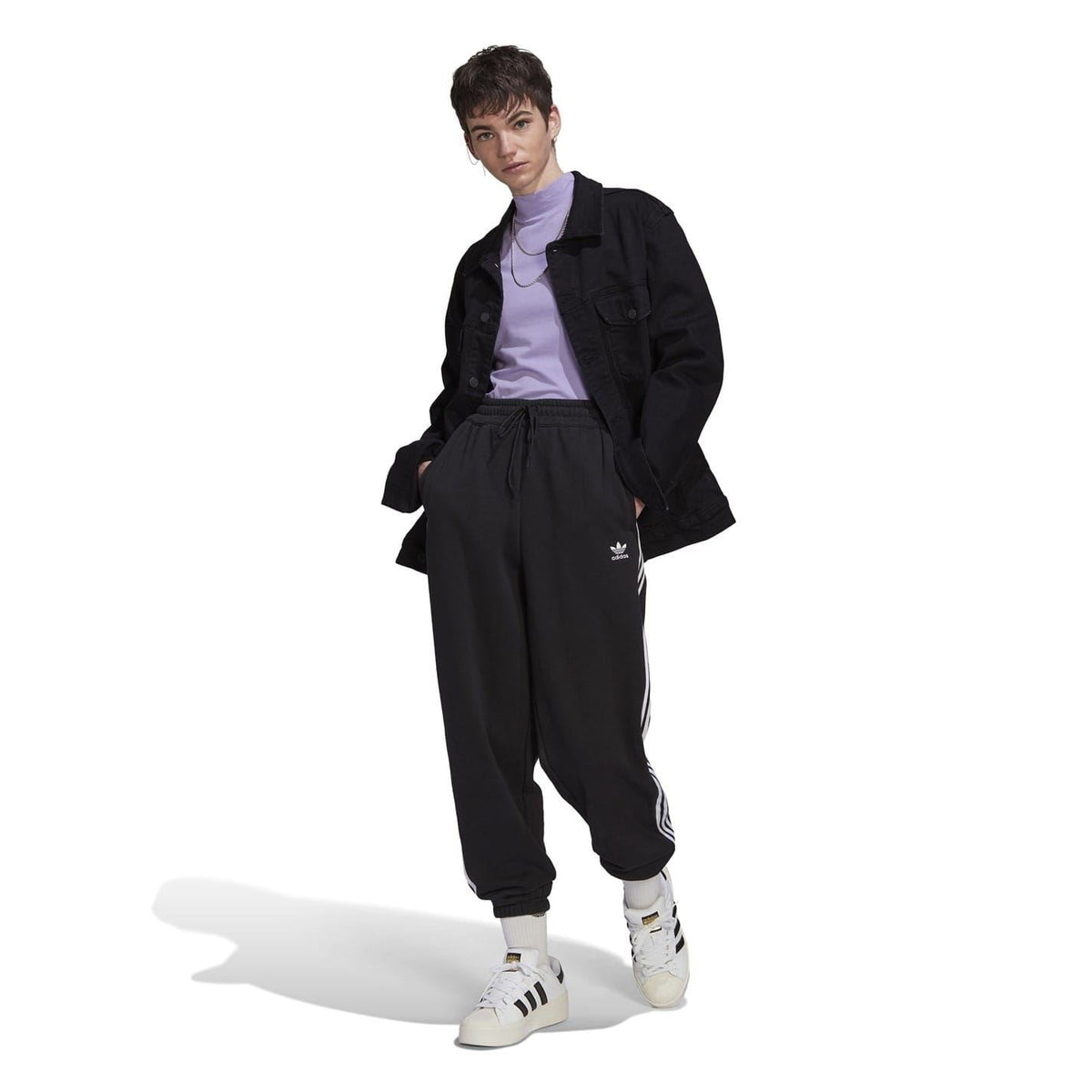 adidas Originals relaxed joggers showing their comfortable fit, tapered design, and signature logo on the leg in a casual streetwear style