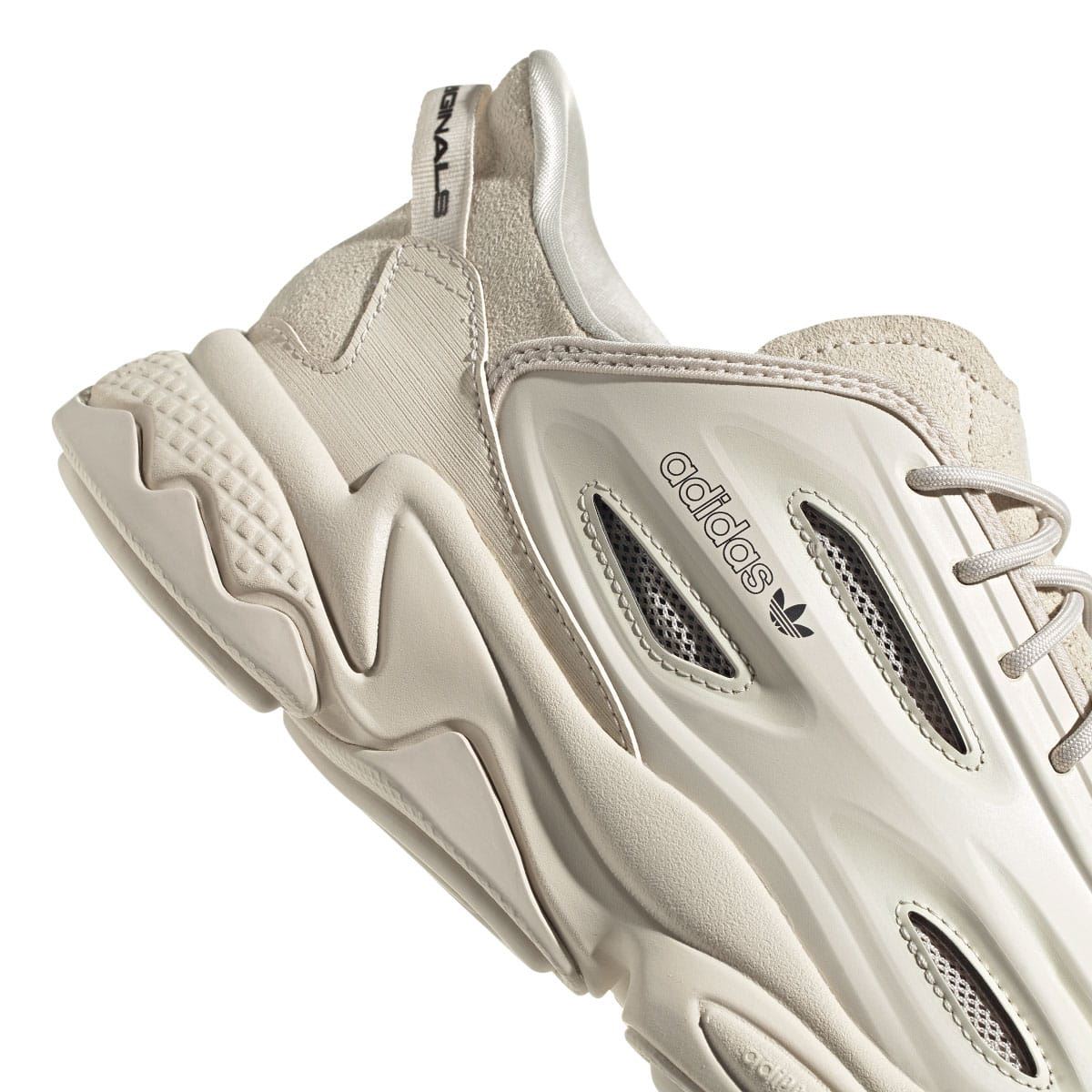adidas Ozweego trainers close-up of side panel in light cream with perforations and logo