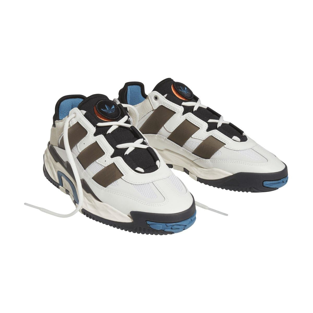 Niteball low-top sneakers, pair angled in white with black straps and blue soles