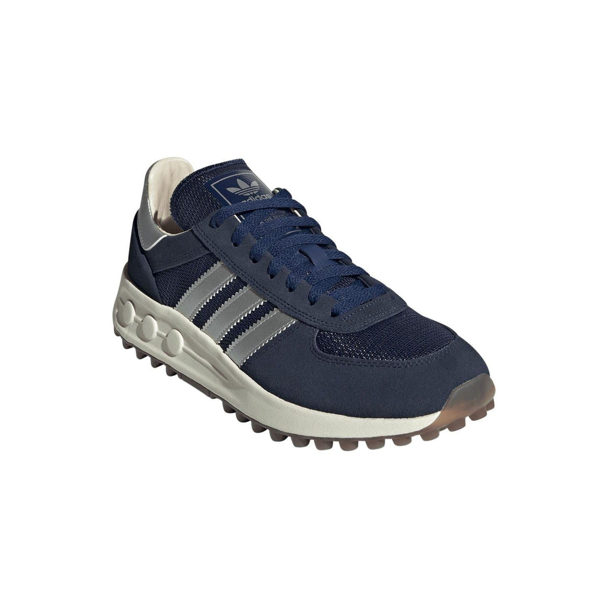 Navy suede-look low-top trainer with lace-up, white stripes, and chunky rubber tread