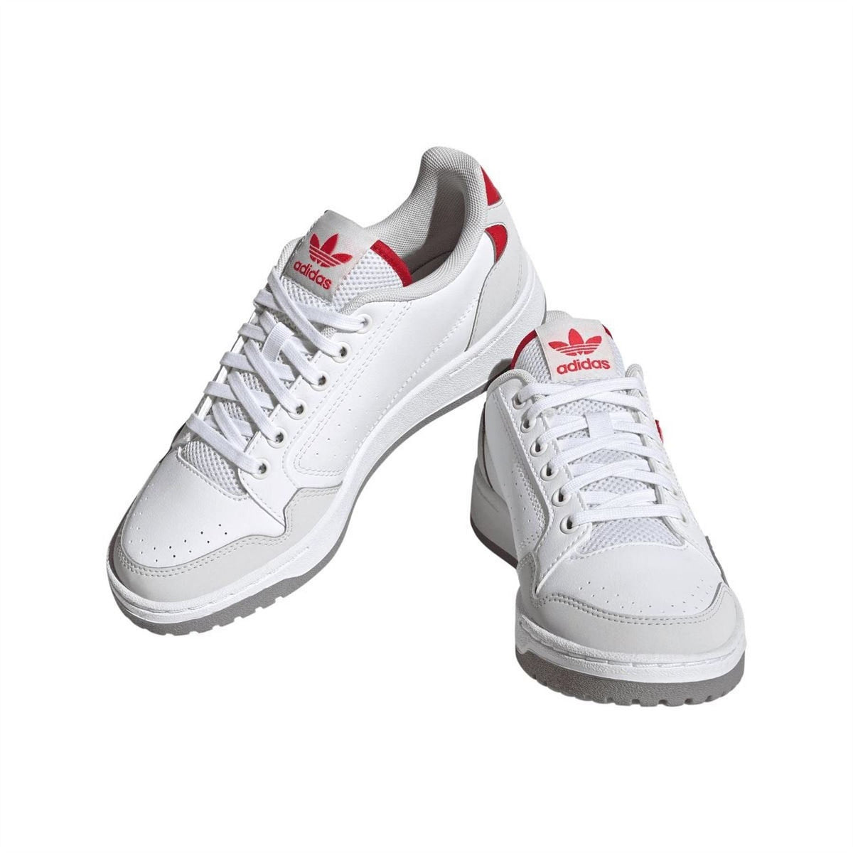 White lace-up trainers with red heel accents and adidas trefoil logo on side