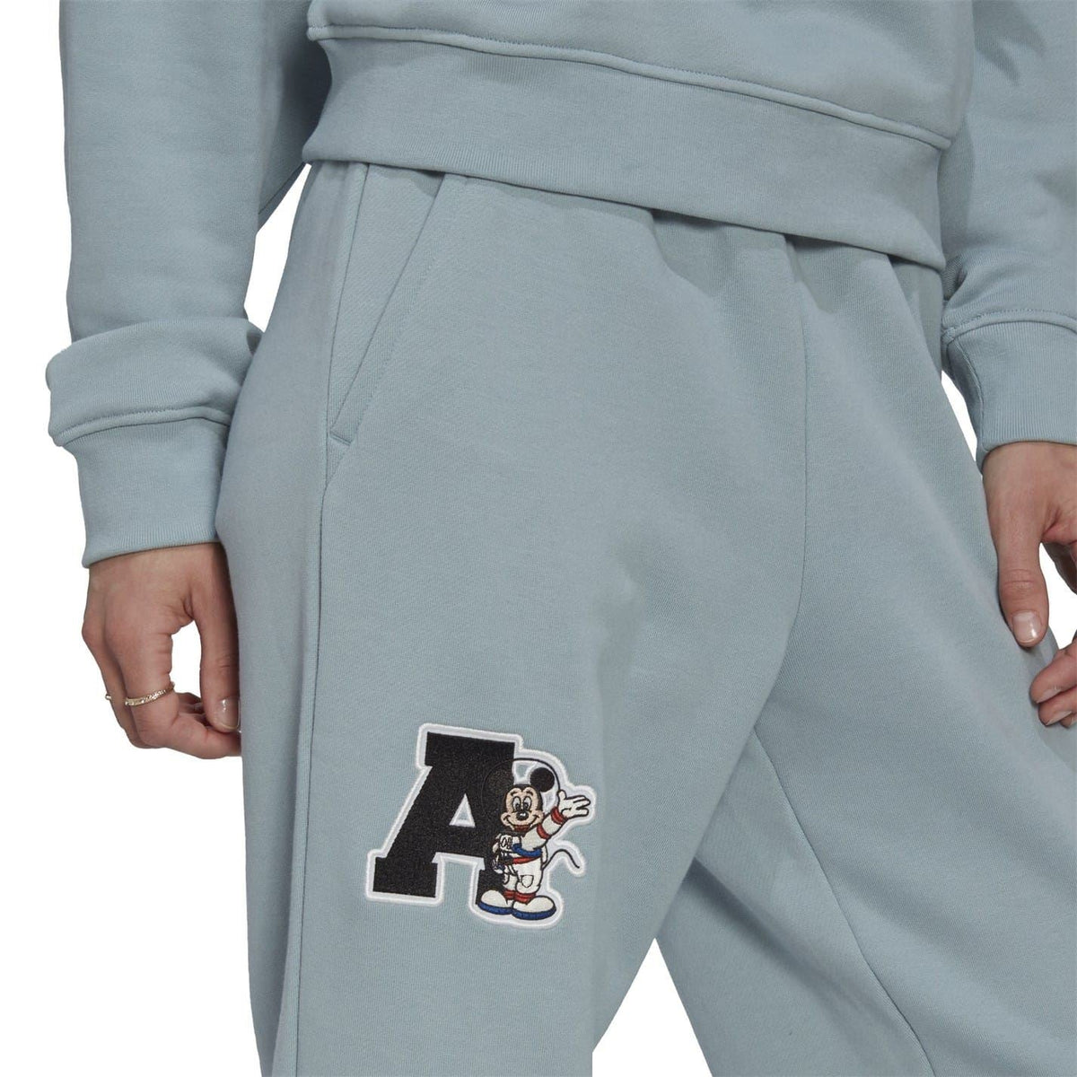 Light grey joggers with Mickey Mouse “A” patch on the thigh