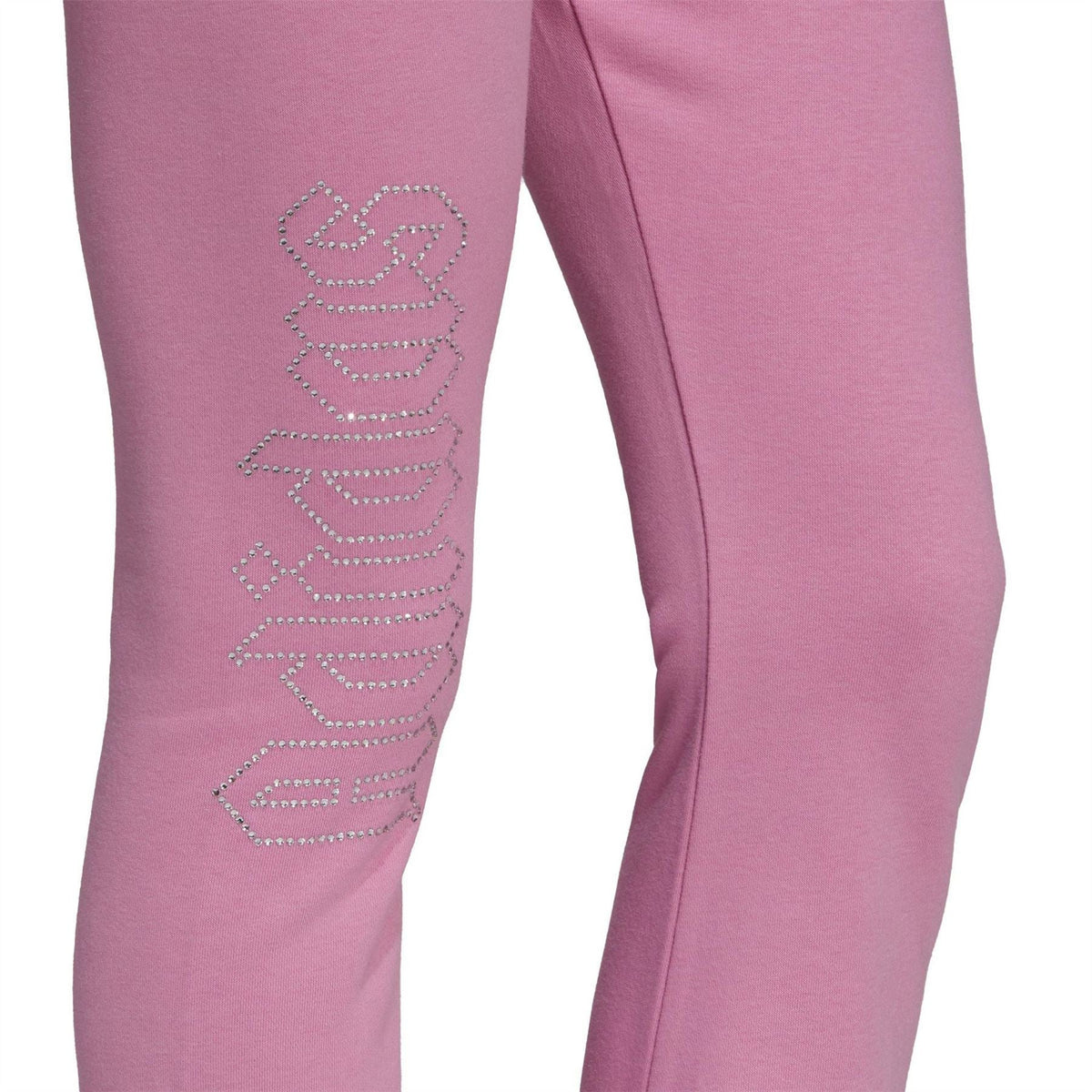 Close-up of pink adidas Originals flared jogger leg with rhinestone-style logo graphic