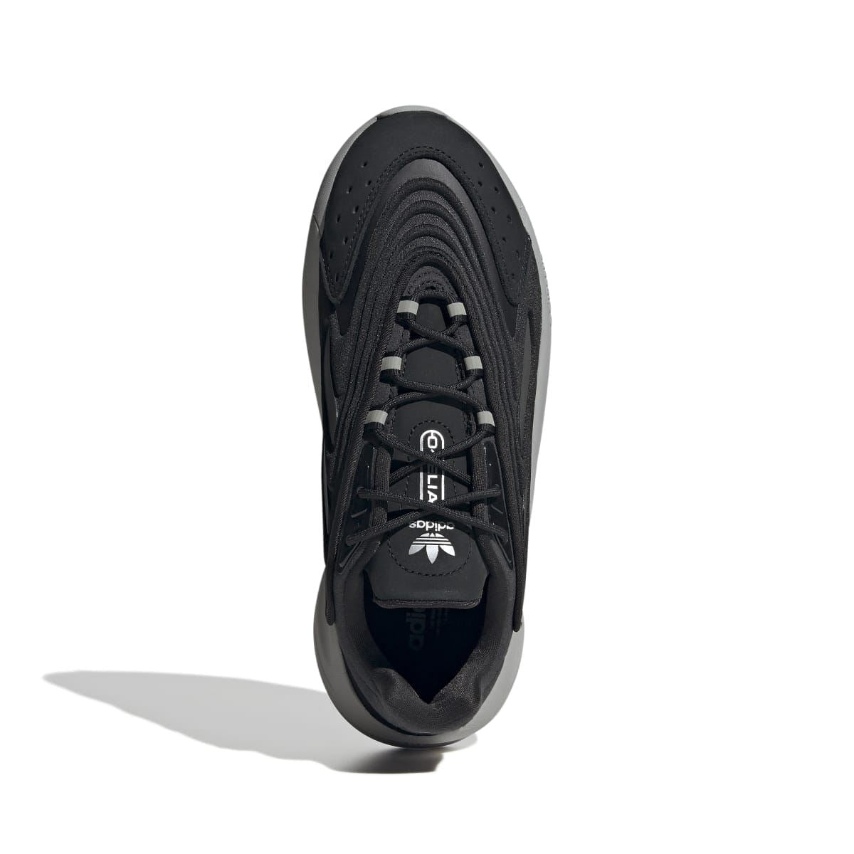 Black lace-up sneaker front view with perforated toe and cushioned collar