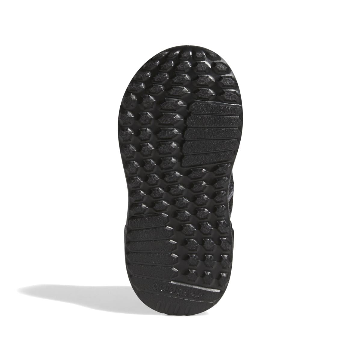 Infant trainers outsole with textured tread for grip, black rubber bottom.