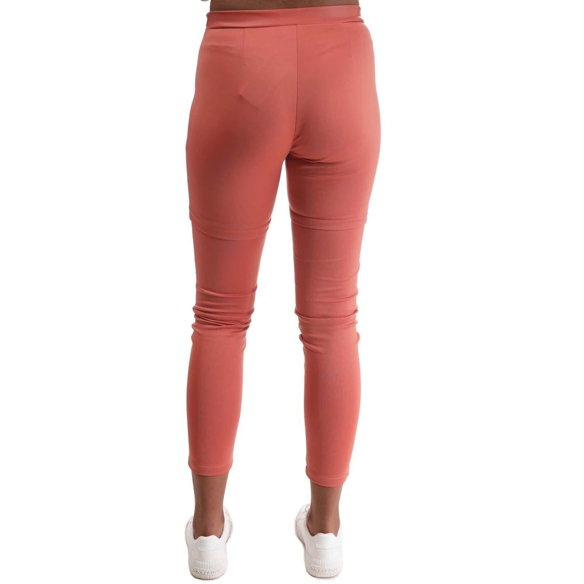 Red slim snap-button pants with stitched seams and tapered ankle cuffs