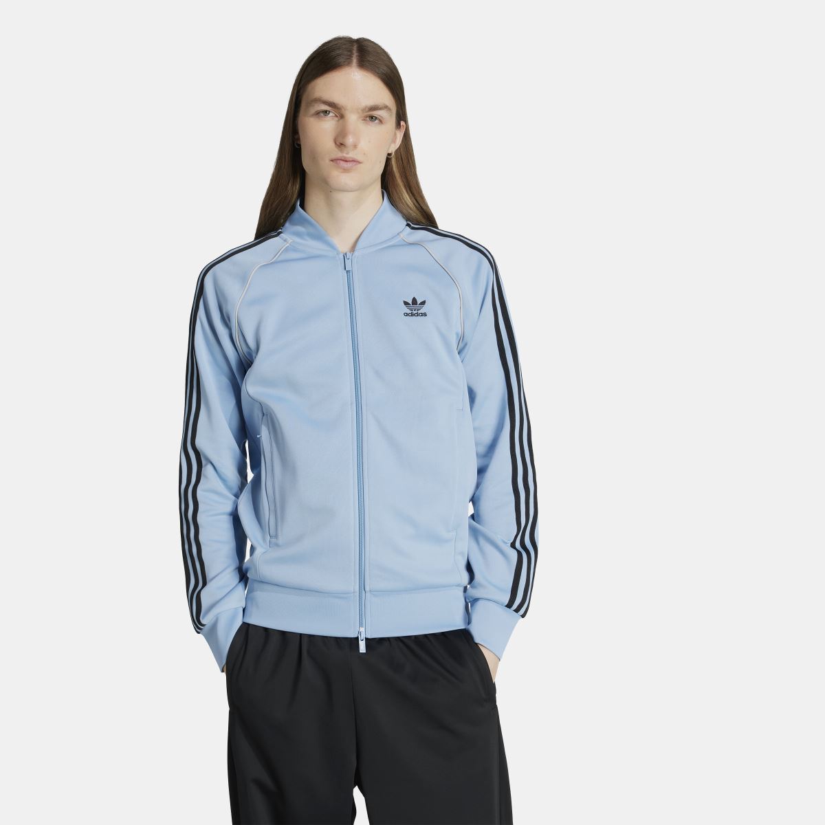 adidas Originals Adicolor Classic SST track jacket in blue with white stripes, featuring a zip-up front and stand collar.