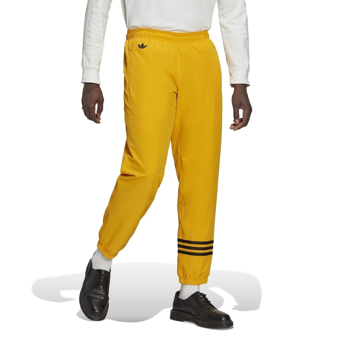 Gold joggers with black striped ankle hem and elastic cuff opening