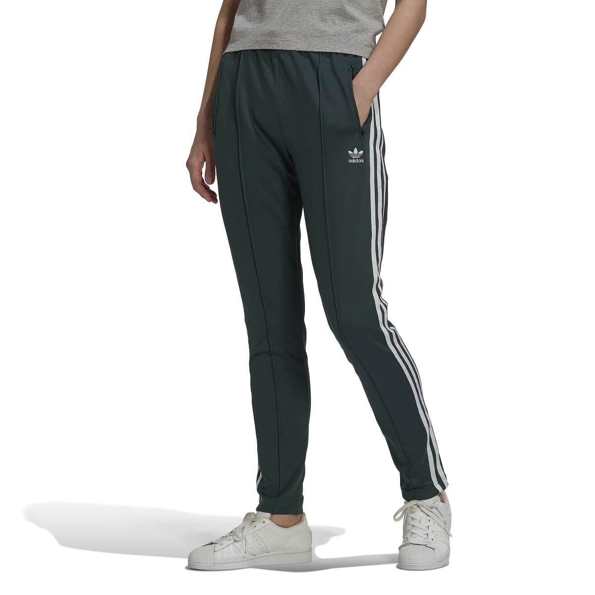 Dark green track pants with three white stripe down each leg; tapering fit