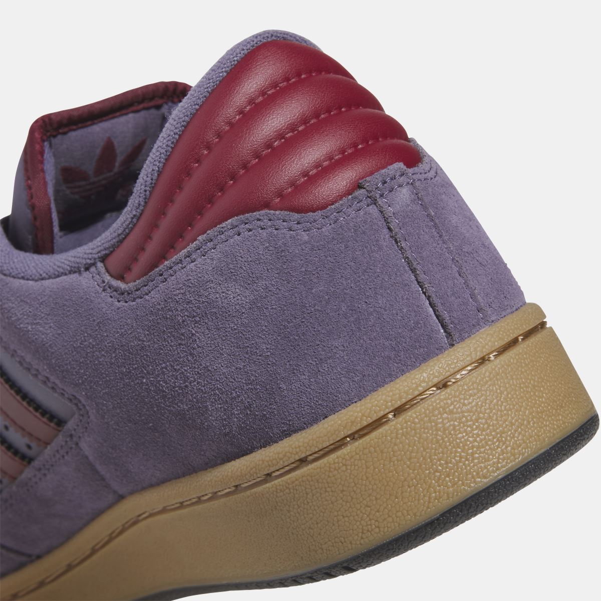 Violet suede adidas Originals low-top shoe close-up of heel panel and gum sole