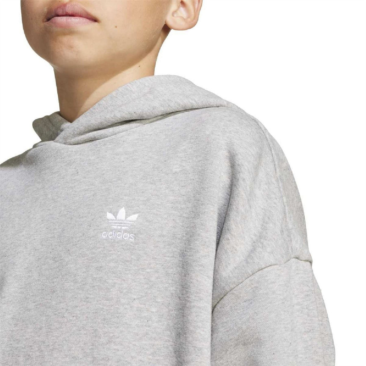 Close-up of adidas logo on grey juniors loose hoodie shoulder