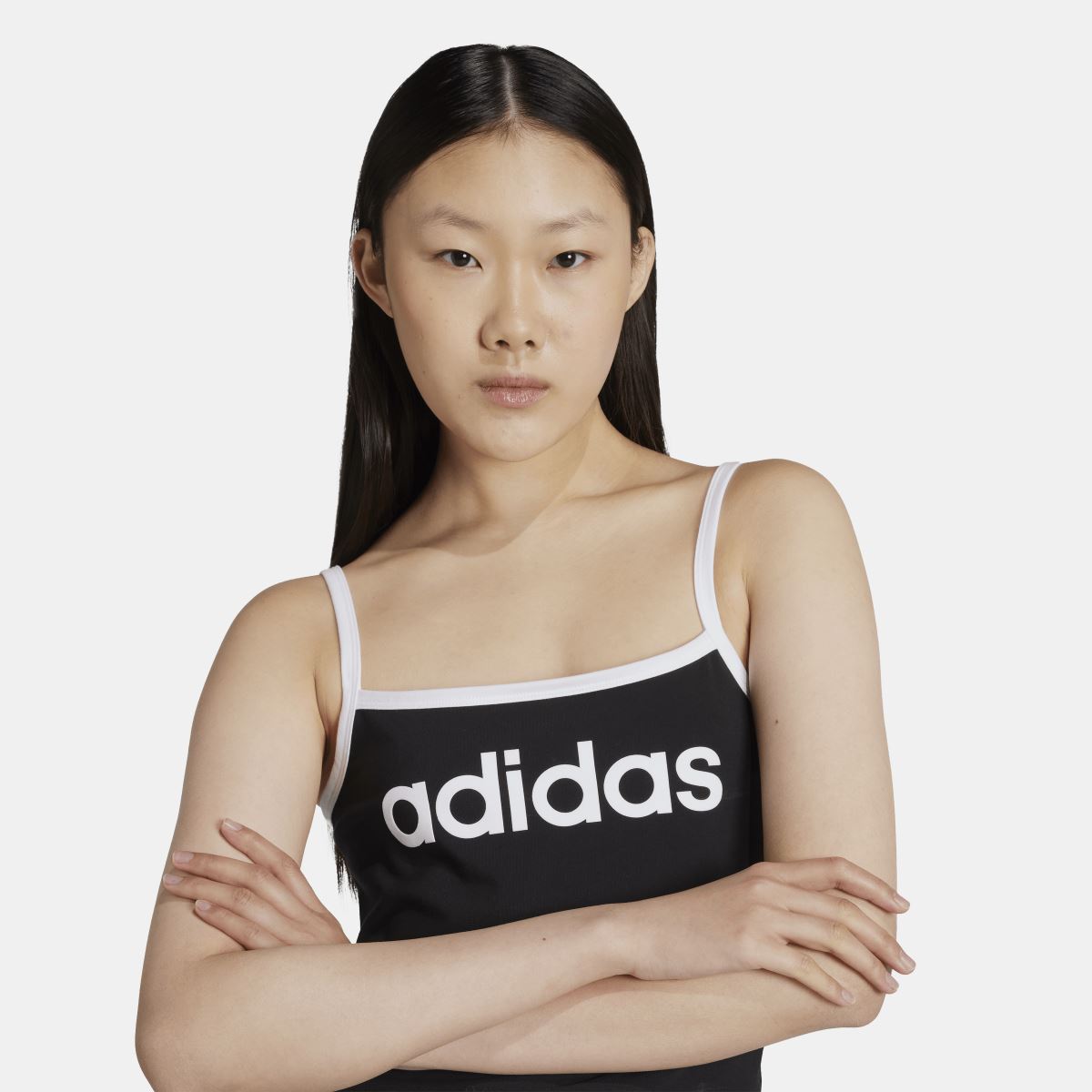Black adidas tank top with wide logo panel on front and thin white-trim straps