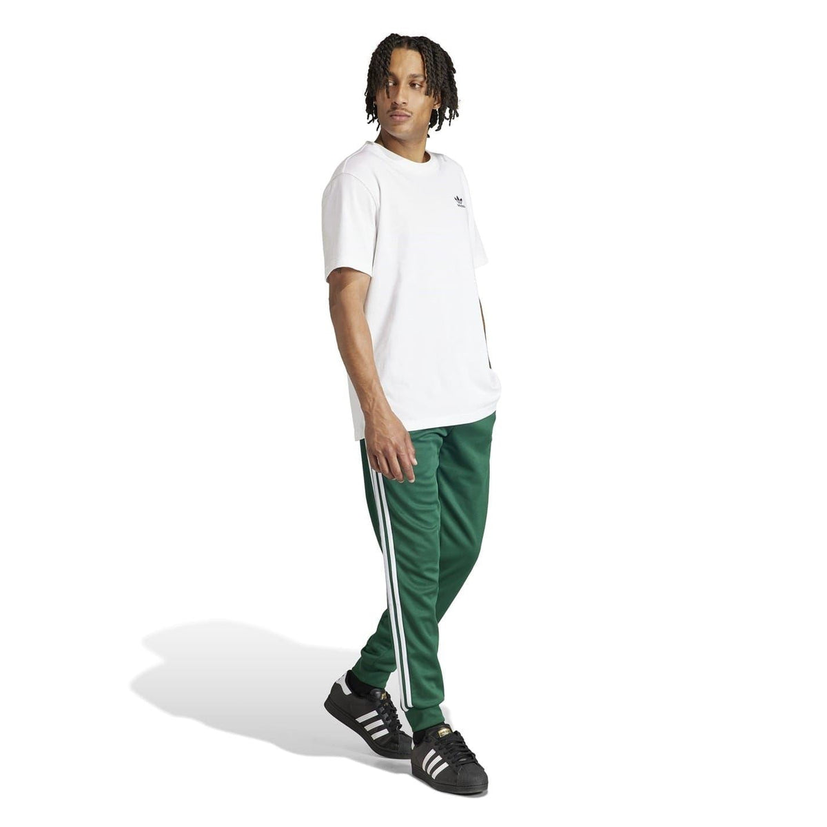 Green slim track pants with white side stripes and elastic waistband
