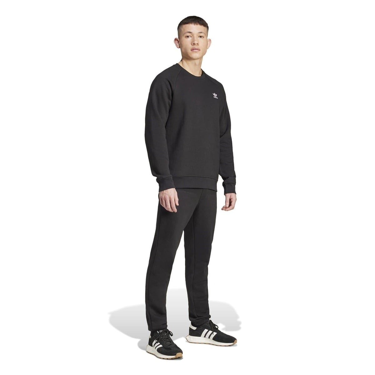 Black slim-fit sweatpants with small adidas logo on the thigh