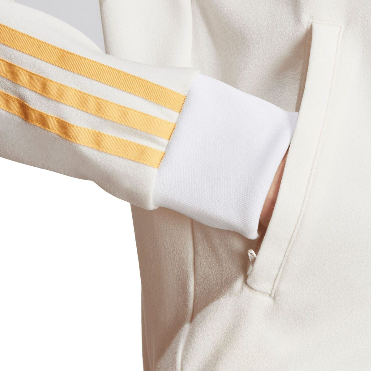 Off-white track top sleeve cuff with gold triple stripes and ribbed trim