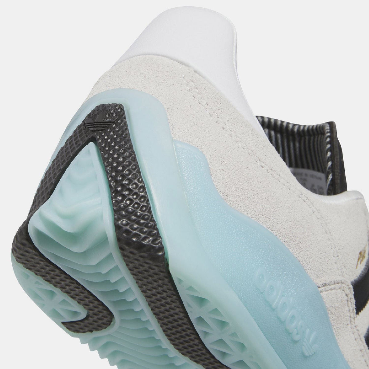 Close-up of white heel panel and light blue sidewall with adidas branding.