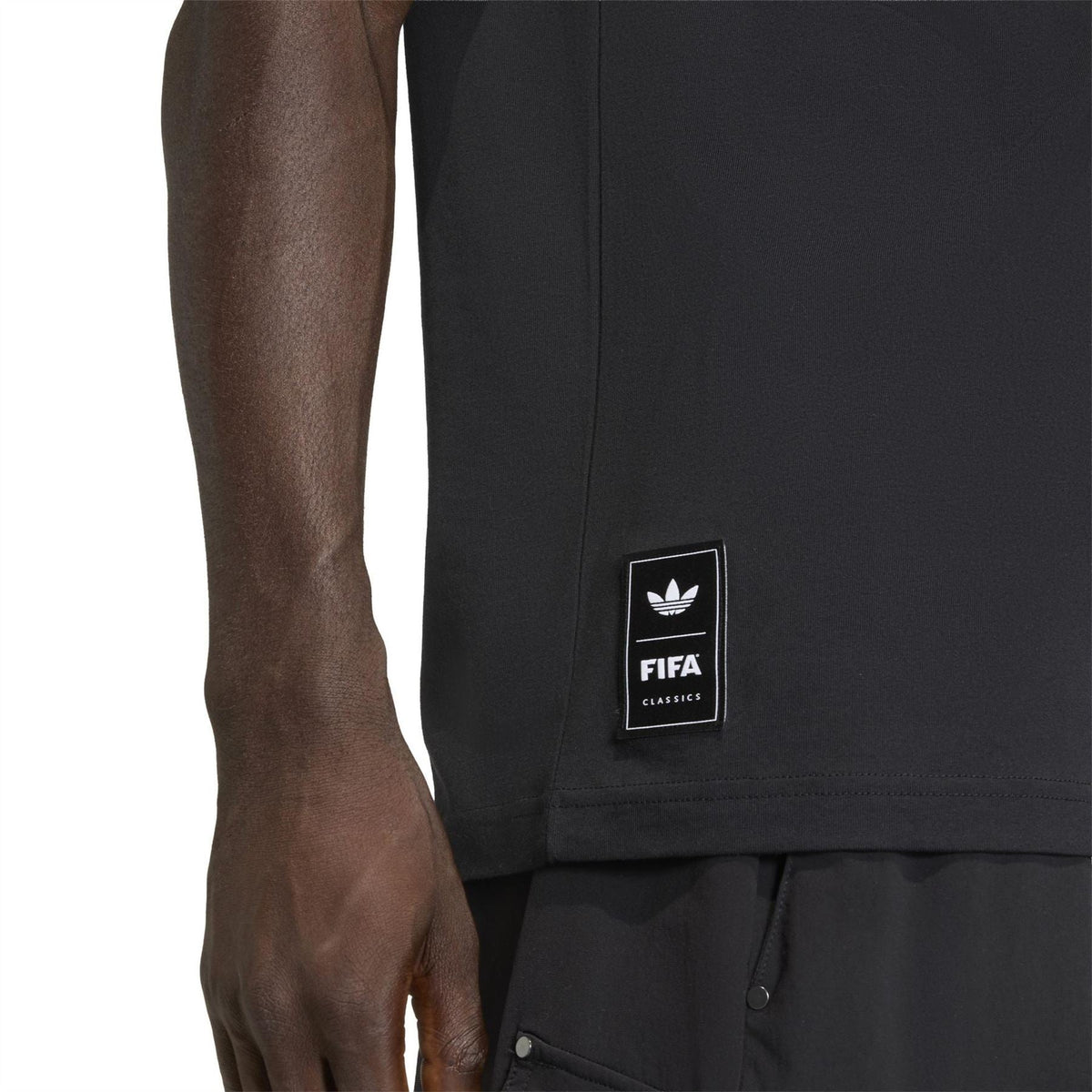Black T-shirt sleeve with FIFA Classics logo patch on side hem