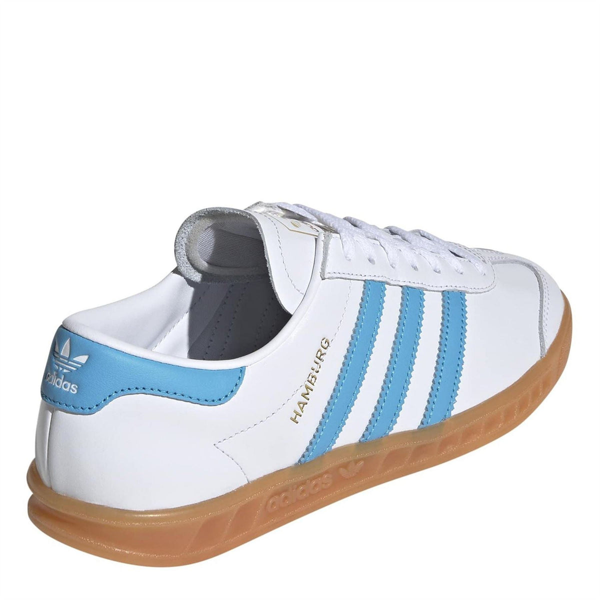 White leather trainers with light blue heel panel, gum sole, and side stripes