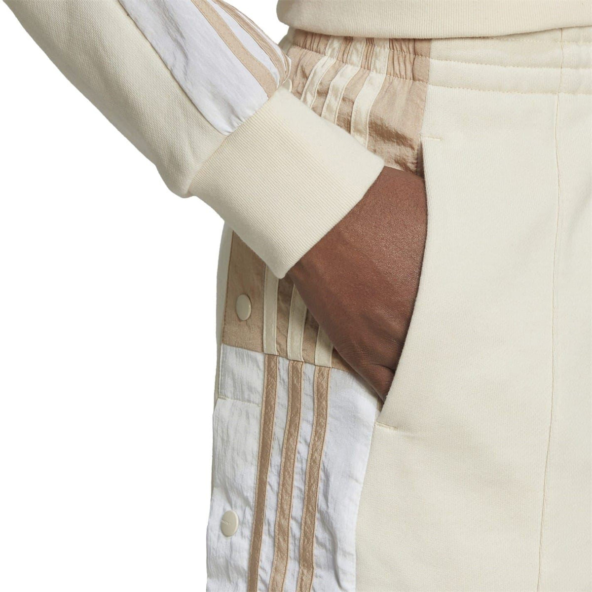 Light mini skirt detail with striped panel, snap buttons, and elastic waistband