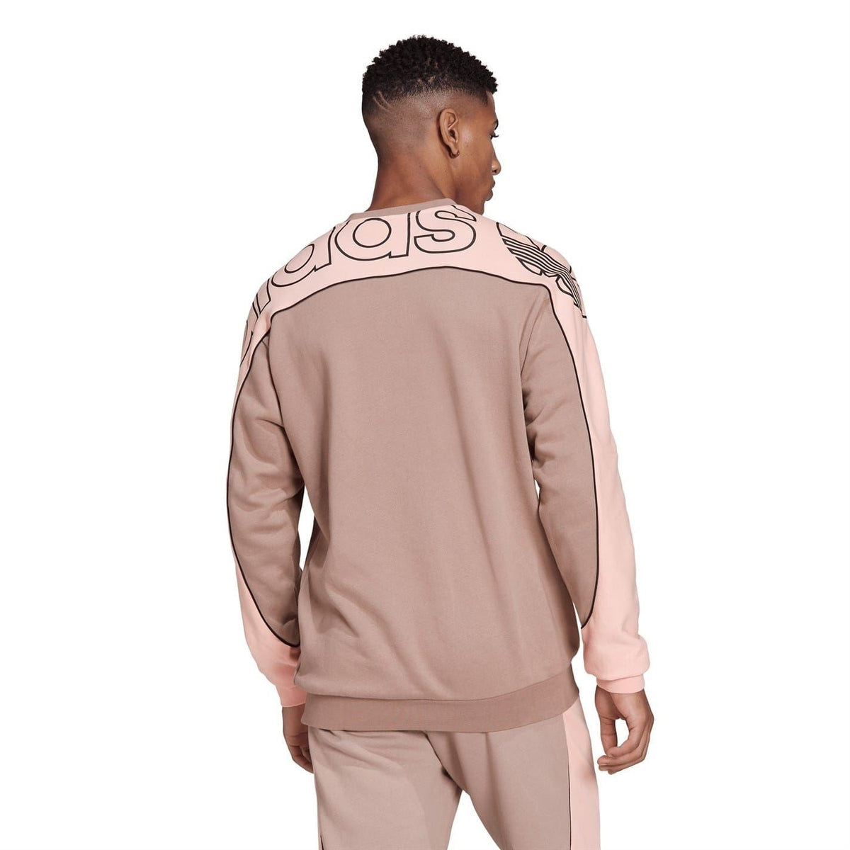 Back view relaxed crewneck sweatshirt in chalky brown with pink side seams and adidas graphics