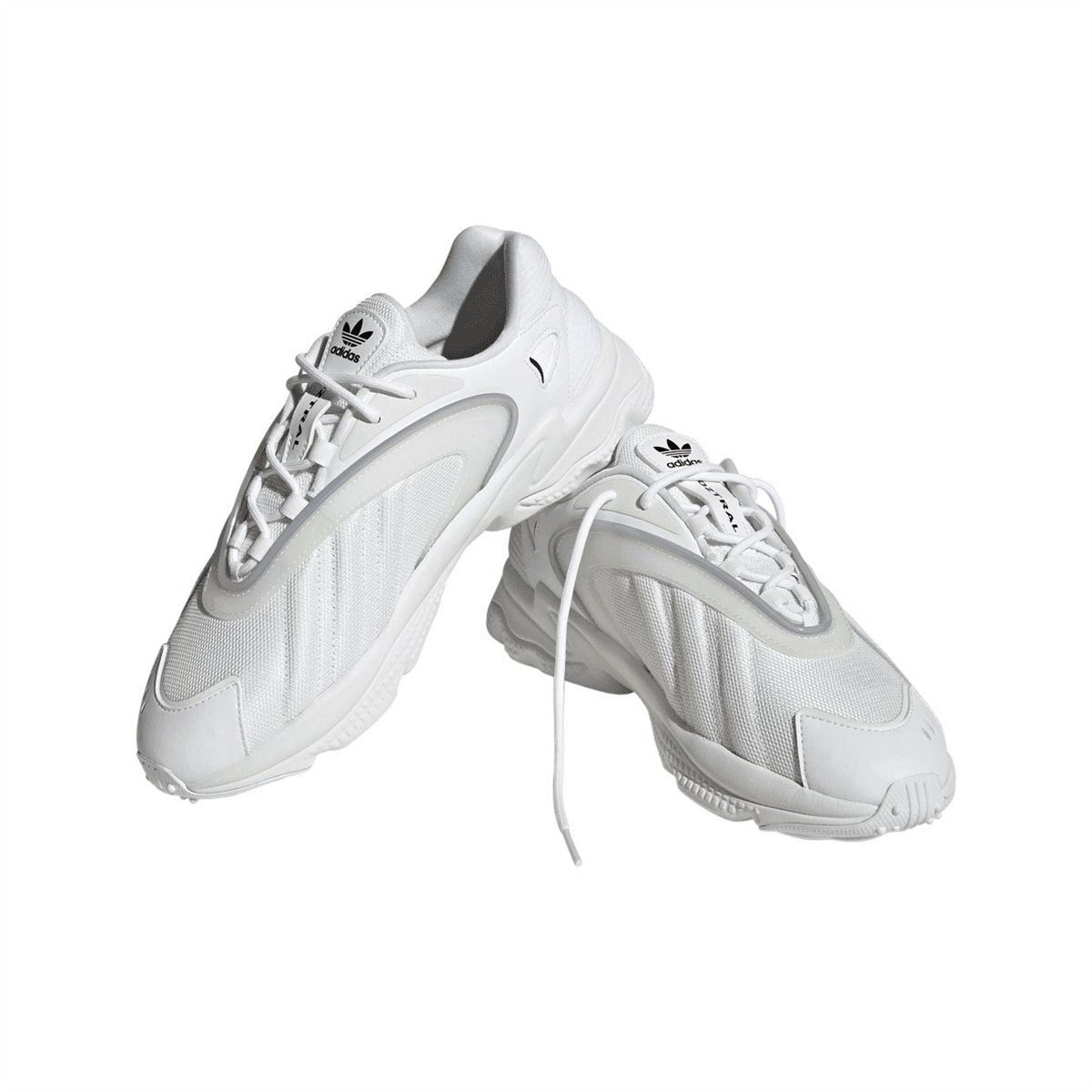 White adidas Originals trainers pair, diagonal view with laces and side logo