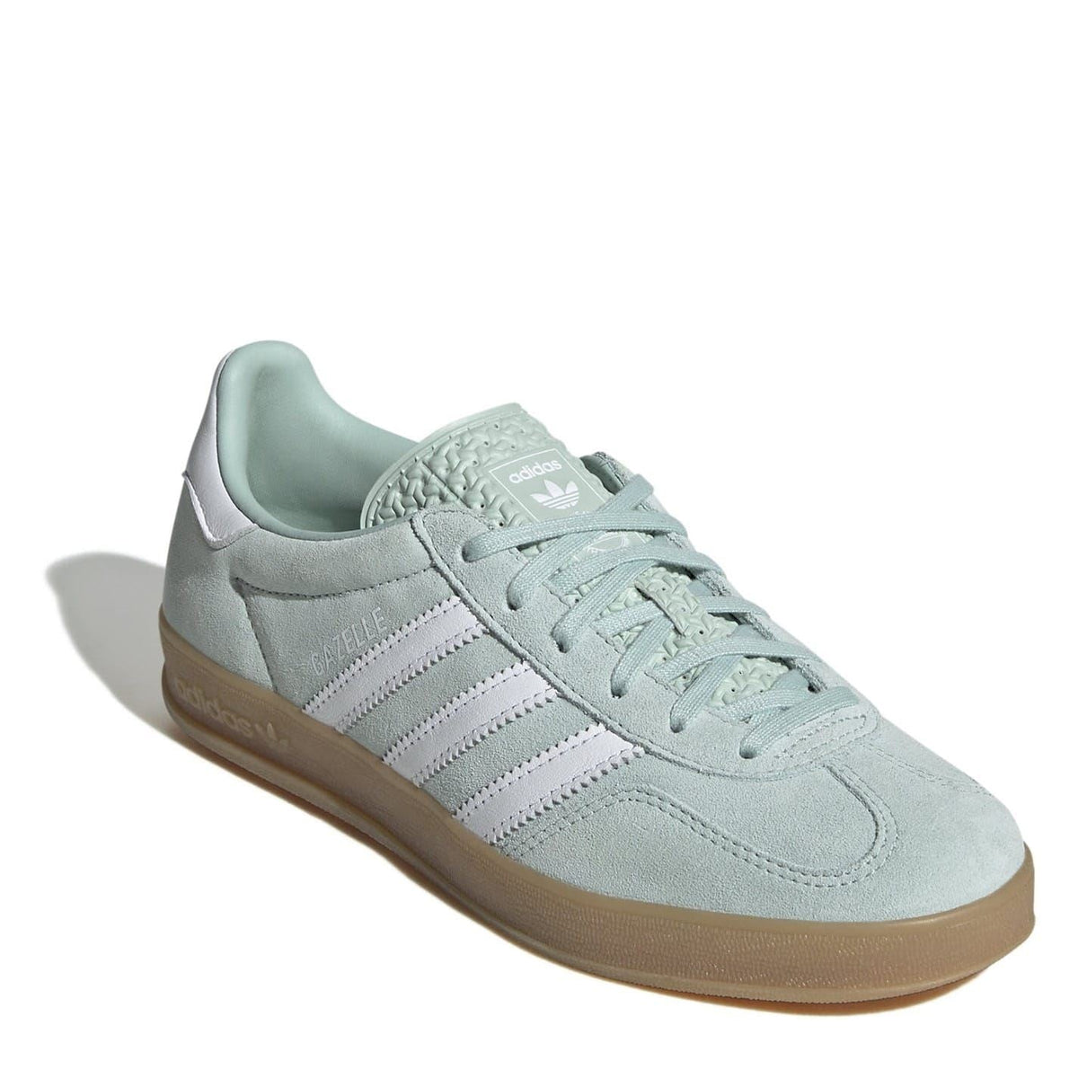 Light aqua suede low-top trainers with lace-up closure, adidas stripes, and gum sole.