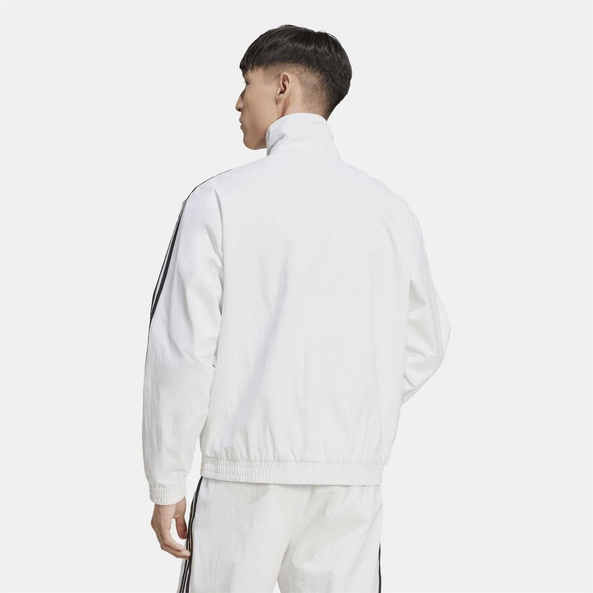 White Firebird track top back with ribbed hem and black triple stripe sleeve panels